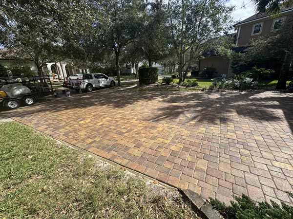 A completed paver driveway sealing job in a Palm Coast neighborhood